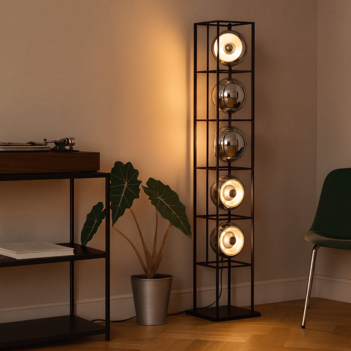 Orbit Bauhaus Floor Lamp — Black beside record console at dusk