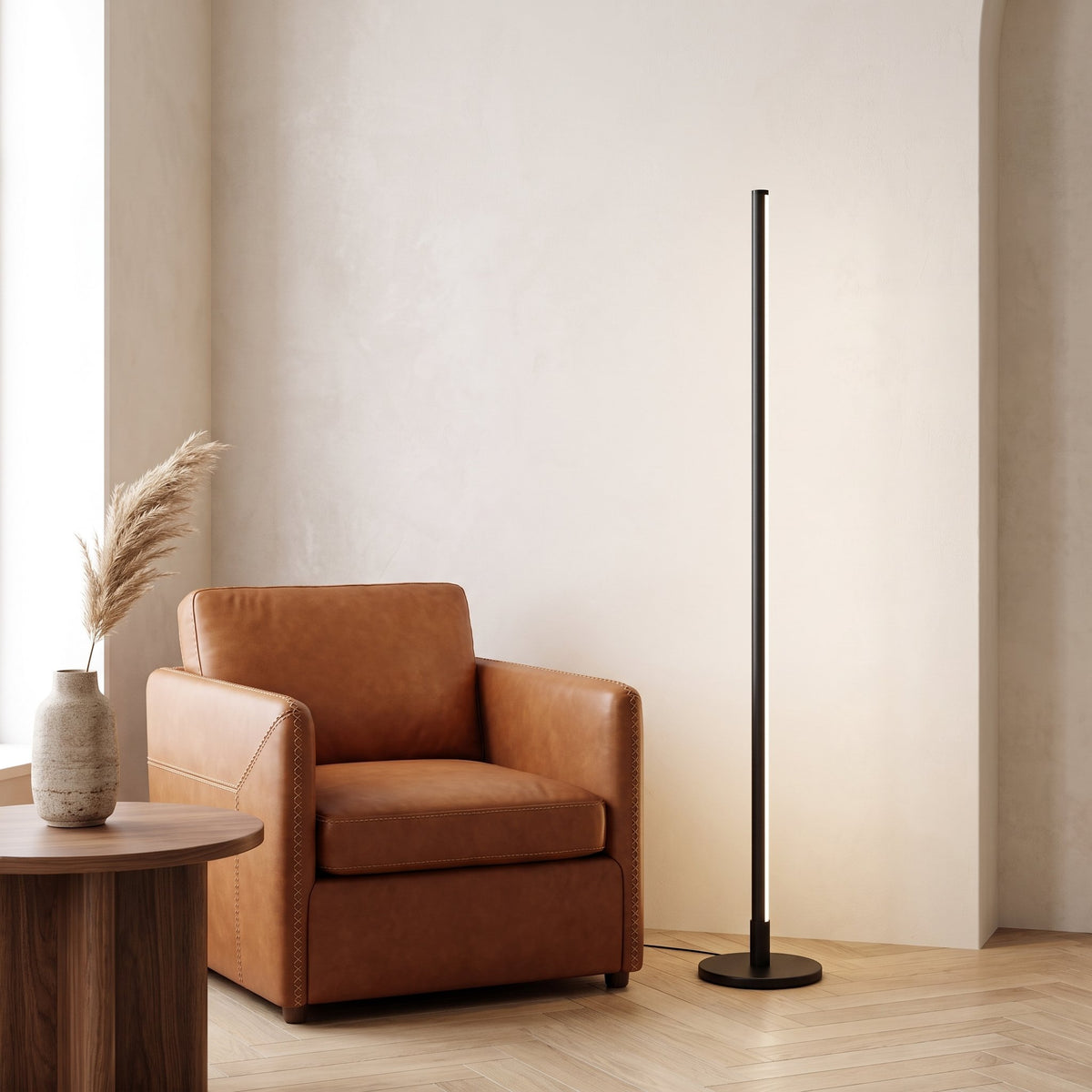 Stelo Slim Floor Lamp — living room corner with leather armchair