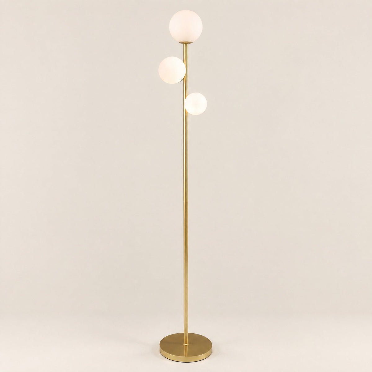 Trio Globe Floor Lamp — Gold hero, off-white background
