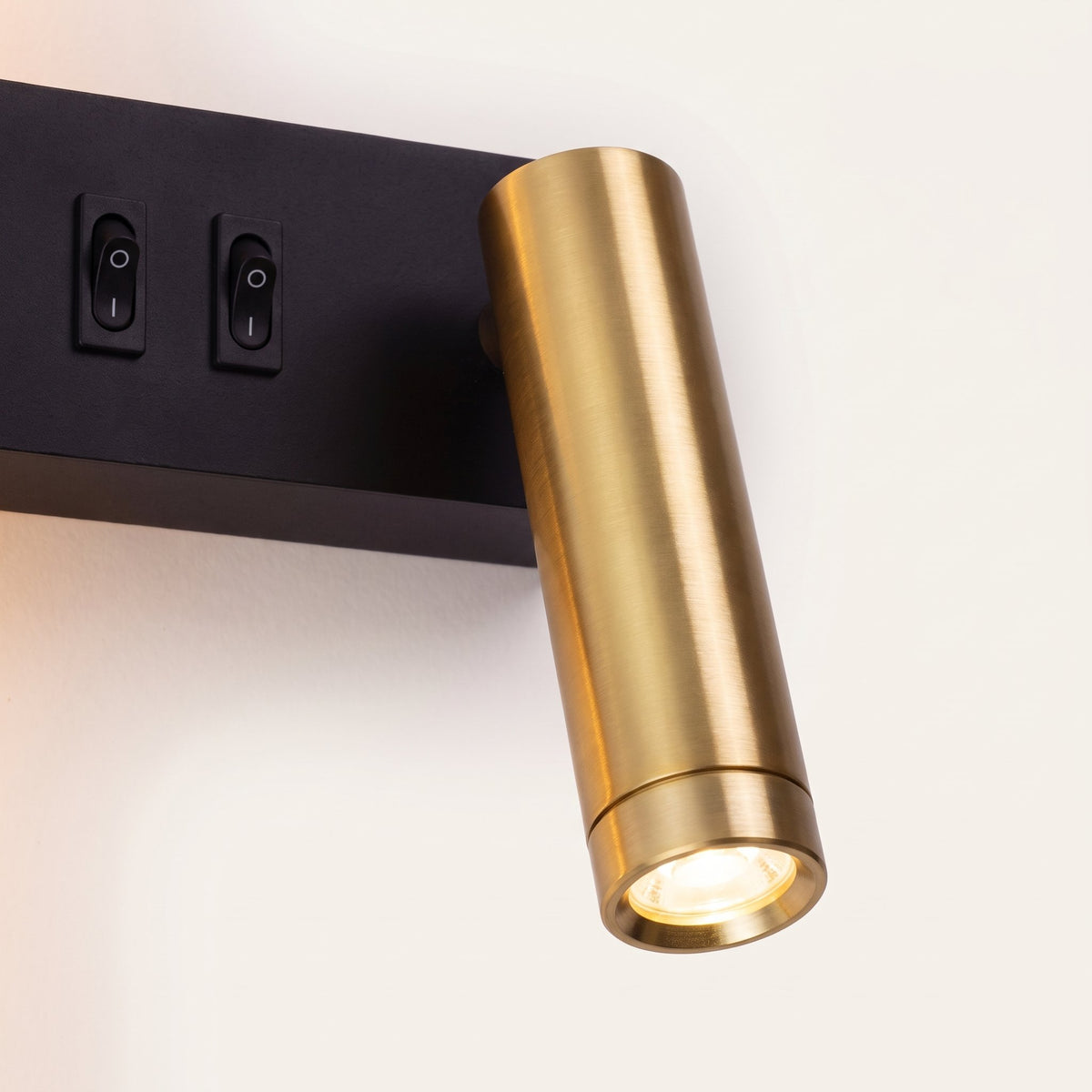 OsloGlow Wall Light - close-up of brass reading spot and switches