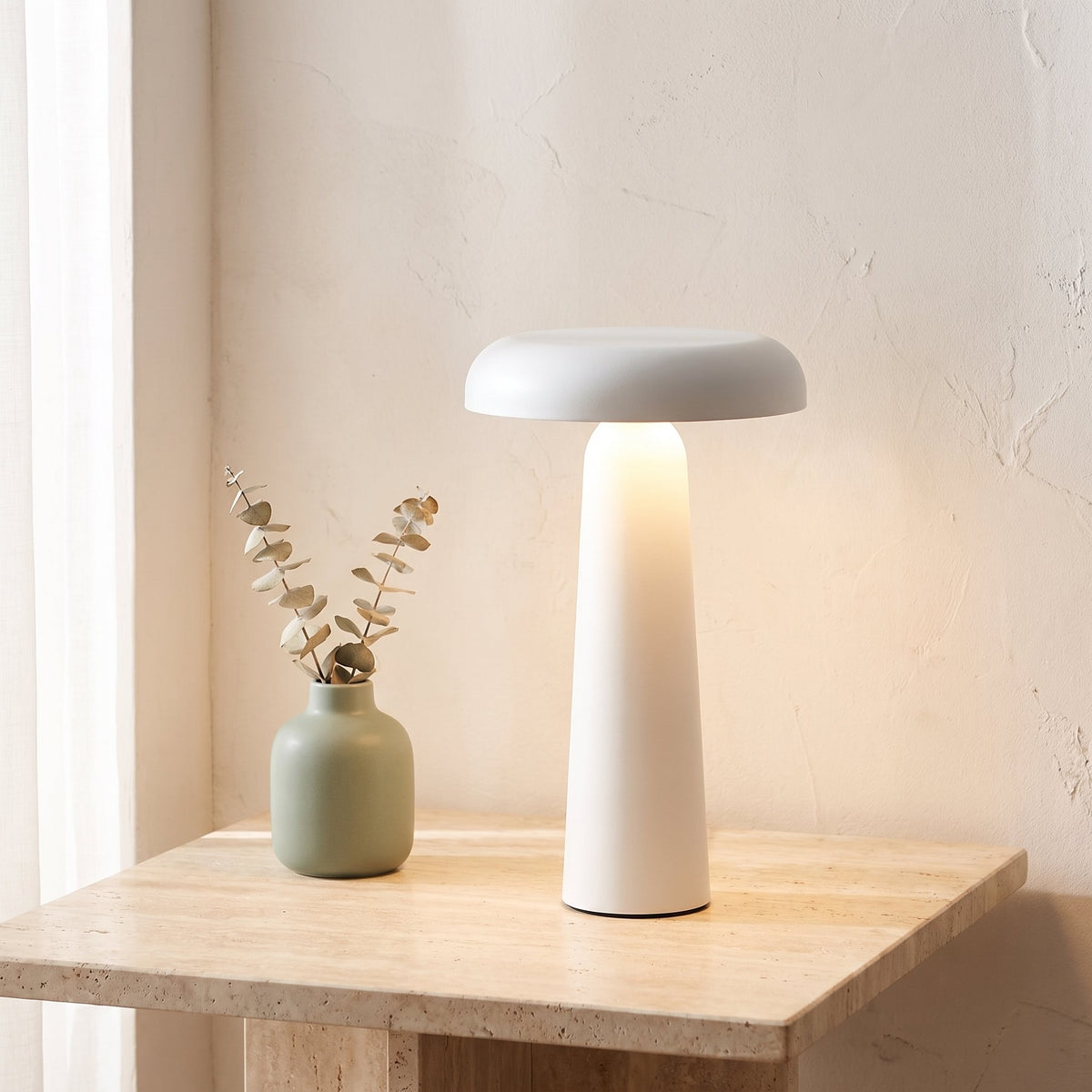 Porcini Table Lamp — White, lit, on travertine