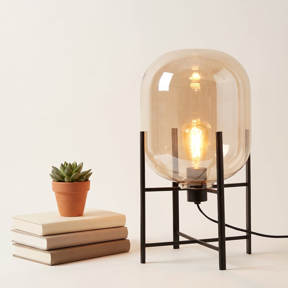 Nimbus Glass Floor Lamp — Amber detail with books