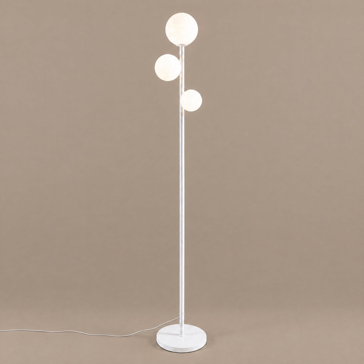 Trio Globe Floor Lamp — White hero, warm taupe background