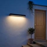 Lintel Linear Wall Light — front door at night