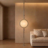 Chrome Globe Column Lamp — warm taupe living room with cream sofa