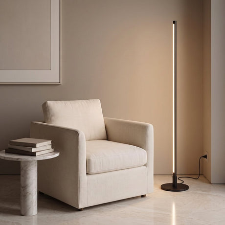 Stelo Slim Floor Lamp — reading nook with linen armchair