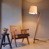 Timber Tilt Floor Lamp — living room with cane accent chair