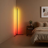 Pulse RGB Floor Lamp — amber-red glow in cozy bedroom