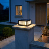 Sillar Ribbed Pillar Light — lit at dusk by the entrance