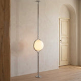Chrome Globe Column Lamp — off-white plaster room with arched doorway