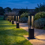 Rowan Aluminum Bollard Light — lifestyle, warm garden pathway at dusk
