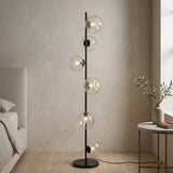 Auralis Glass Floor Lamp — Black frame, Transparent glass in bedroom setting