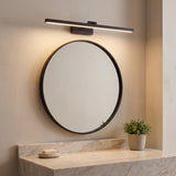 Pivot Vanity Light Bar lit warm above a round bathroom mirror
