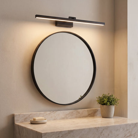 Pivot Vanity Light Bar lit warm above a round bathroom mirror