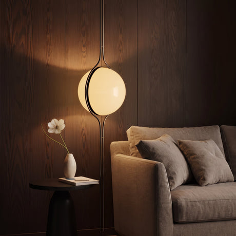 Chrome Globe Column Lamp — moody wood-panel living room