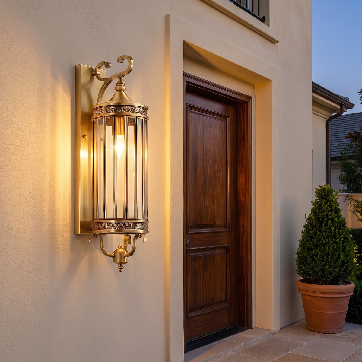 Corbel Wall Lantern — lit beside a front door at dusk