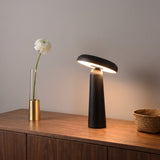 Porcini Table Lamp — Black, lit, on walnut sideboard