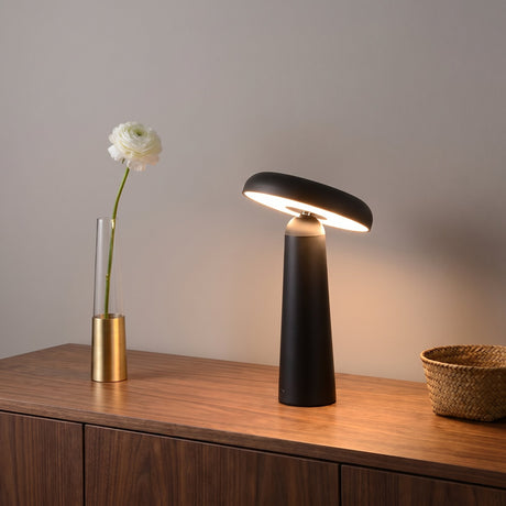 Porcini Table Lamp — Black, lit, on walnut sideboard