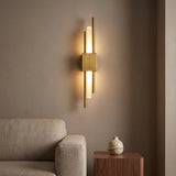 Duo Twin Rod Wall Sconce — lit in a living room at dusk