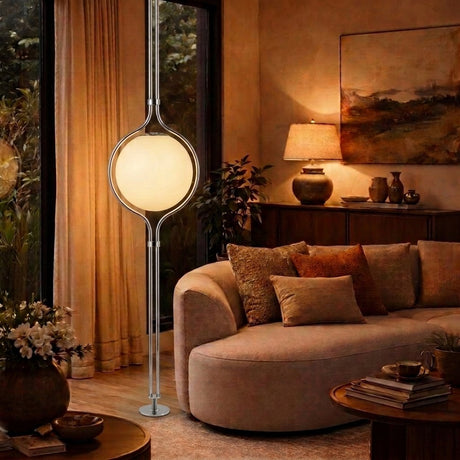 Chrome Globe Column Lamp — dusk living room with garden view