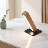 Linea Wood Strip Lamp — Wood tilted on marble desk, lifestyle
