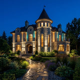 Aperture Beam Spotlight — stone villa with a round turret lit at night by warm white beams