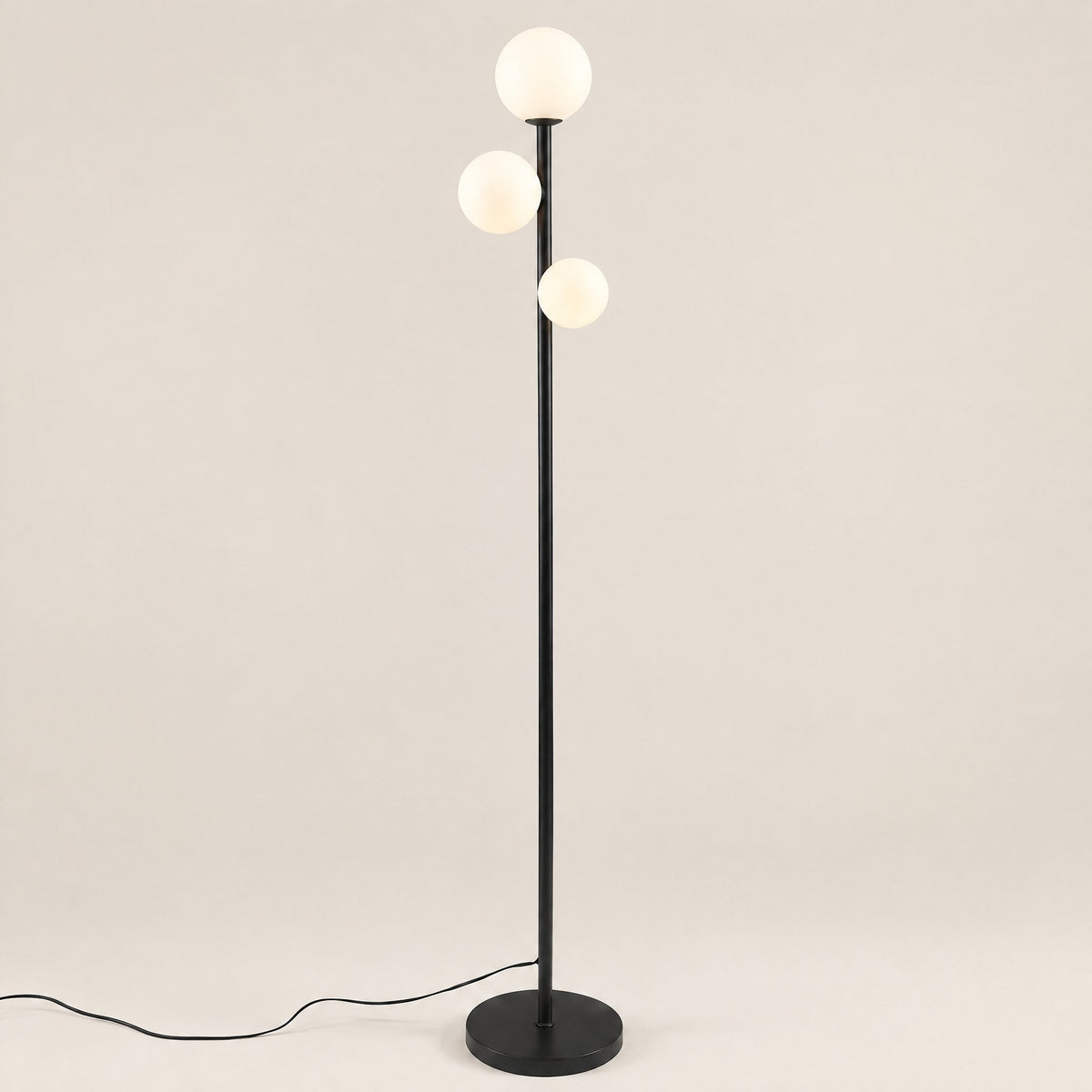 Trio Globe Floor Lamp — Black hero, off-white background