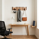 Orlo Piano Key Coat Rack — above a home office desk with headphones and a blazer