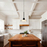 Puck Glass Pendant — clear glass above a wood kitchen island