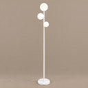 Trio Globe Floor Lamp — White hero, warm taupe background