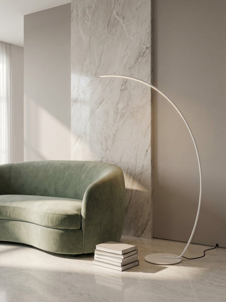 Crescent Arc Floor Lamp — White, in a living room near a marble wall