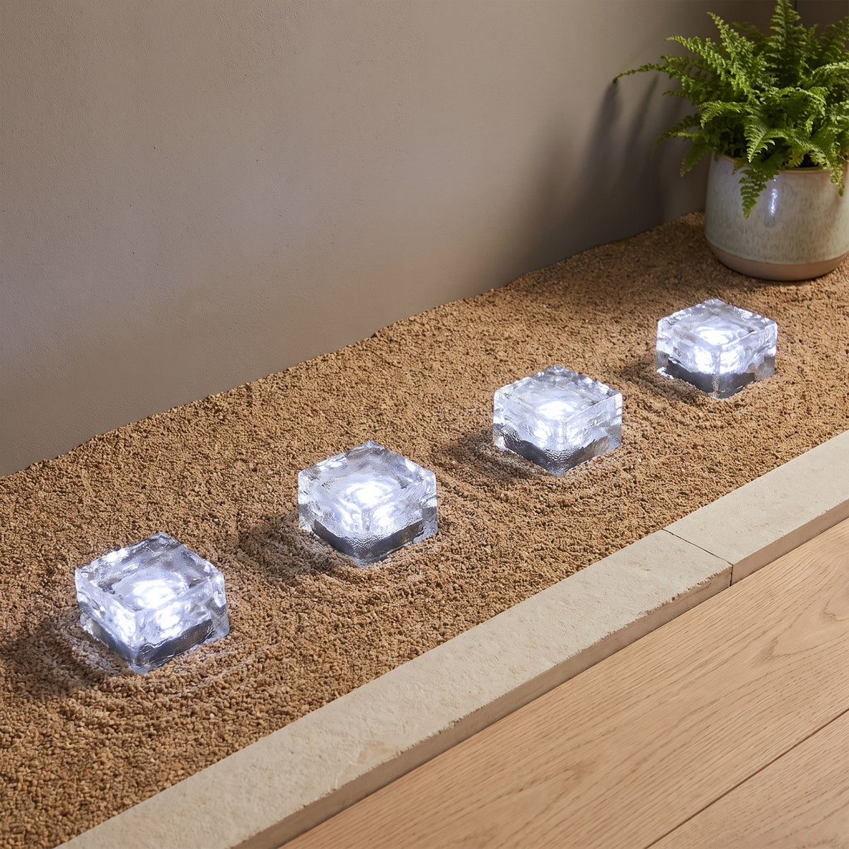Glacier Solar Paver Light — patio edge at dusk