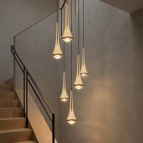 Teardrop Mini Pendant — Gold pendant cluster in a stairwell at dusk