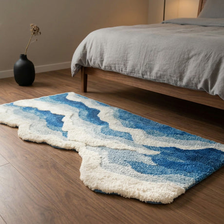 Oceanique Ocean Wave Area Rug — bedroom scene with walnut floor and grey linen