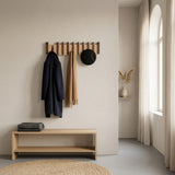 Orlo Piano Key Coat Rack — in a Japandi apartment entry with a navy coat and scarf