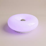 Halo Bauhaus Table Lamp white RGB version glowing violet on a plain studio backdrop