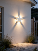 Aurelia Silhouette Wall Sconce - lifestyle image exterior garden gate at dusk