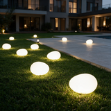 Pebble Glow Landscape Light - lifestyle image pool deck at dusk