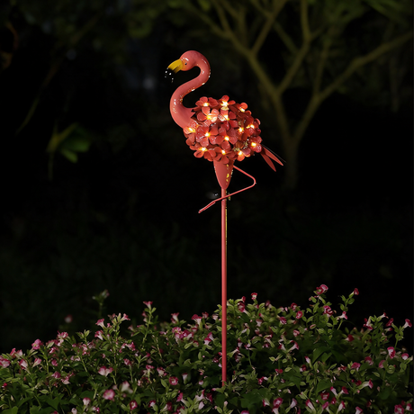 Blossom Flamingo Stake Light - lifestyle image garden border at night