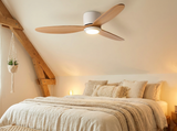 Natural wood ceiling fan in cozy bedroom