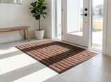 Striped outdoor door mat at a modern entryway