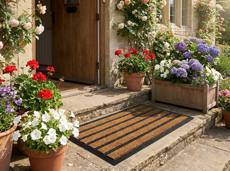 Striped outdoor door mat at a cottage front step