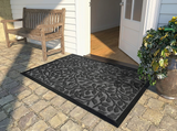Polyester outdoor door mat on a covered front porch