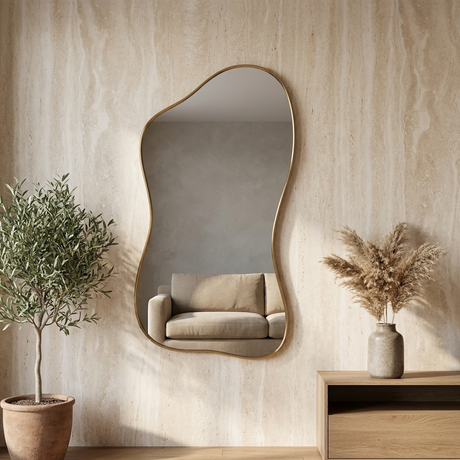 Modern Irregular Floor Mirror, Gold Metal Frame — against a travertine wall