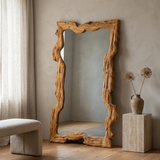 Rustic Solid Wood Mirror, Raw-Cut Pine — hero, leaning against a plaster wall