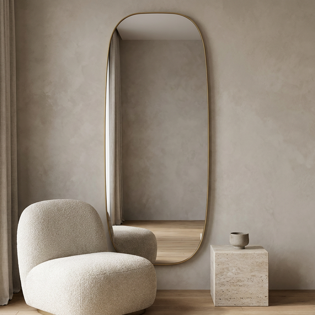 Modern Oval Full Length Wall Mirror, Slim Brass Frame — hero with a bouclé chair