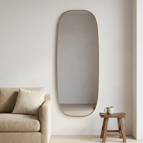 Modern Oval Full Length Wall Mirror, Slim Brass Frame — above a sand linen sofa