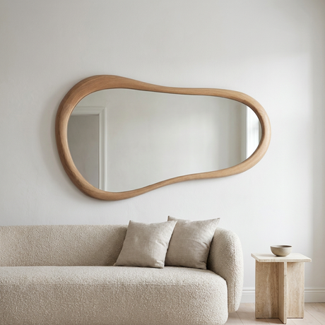 Cloud Shape Wall Mirror, Oak Finish — above a bouclé sofa