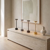 Drift Aluminum Table Lamp — four finishes on a stone sideboard