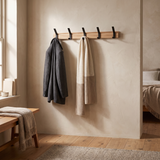 Nordby Adjustable Coat Rack — in a bedroom corner with jacket and scarf